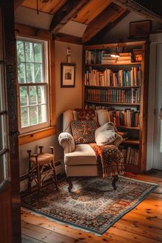 a living room filled with furniture and bookshelves next to a window on top of a wooden floor