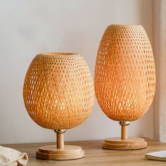 two wooden vases sitting on top of a table