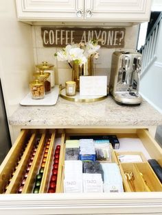 an open drawer in a kitchen filled with coffee