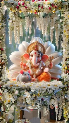 the statue of lord ganeshra is surrounded by flowers and garlanded with beads