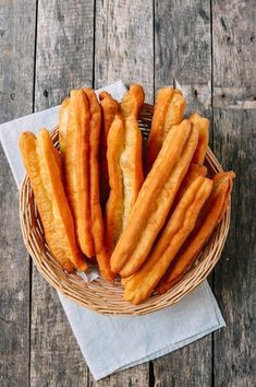 some bread sticks are in a basket on a table