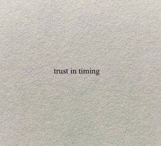 the words trust in time written on white paper