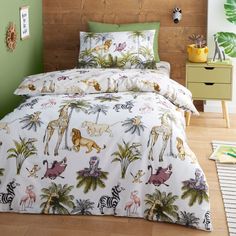 a bed with jungle animals and palm trees on it