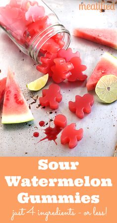 watermelon gummies are in a jar with slices of watermelon next to them