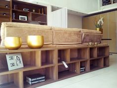 a living room filled with furniture and bookshelves next to a wall mounted book shelf