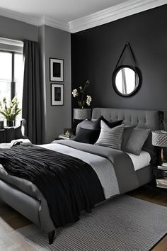 a bedroom with black walls and grey bedding