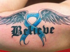 a blue ribbon with wings and the word believe on it is shown in this tattoo design