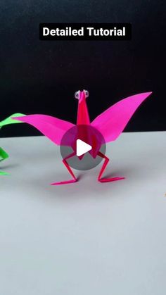 an origami bird is standing on its hind legs with the words detailed video below it