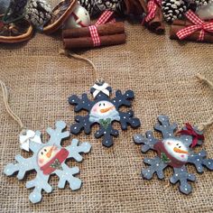 three snowflake ornaments are sitting on a table