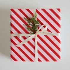 a present wrapped in red and white striped paper