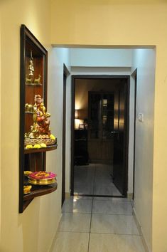 the hallway is lined with shelves filled with decorative items