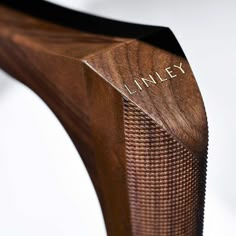 a wooden bench with the name linley engraved on it's backrests