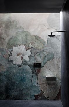 an artisticly designed bathroom with flowers painted on the wall