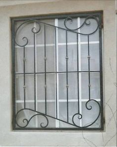 a window with wrought iron bars on it