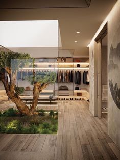 a room with a tree in the middle and clothes hanging on racks to dryer