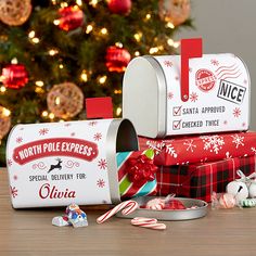 two christmas mailboxes with candy canes in front of a christmas tree