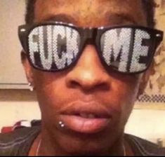 a close up of a person wearing sunglasses with the words rub me written on them