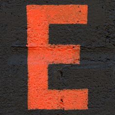 the letter e is painted orange and black