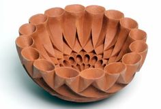 a bowl made out of clay sitting on top of a table