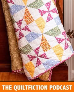 a quilted pillow sitting on top of a wooden table