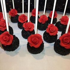 there are many cupcakes with red roses on them