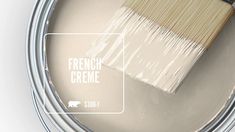 a paint can with a brush in it and the words french creme painted on it