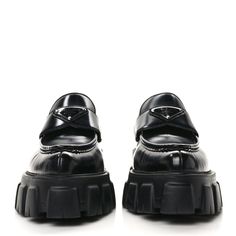 This is an authentic pair of PRADA Spazzolato Triangle Logo Monolith Pointy 55mm Loafers size 38 in Black. These chic platform loafers are crafted of shiny black calfskin leather. They feature pointed toes, triangle Prada logo plaques, and stacked black rubber heels on matching rubber platform soles. Prada Logo, Platform Loafers, Triangle Logo, Rubber Heels, Black Rubber, Calf Skin, Prada, Loafers, ? Logo