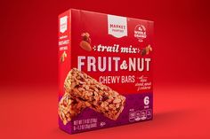 a box of fruit and nut chewy bars on a red background with the label