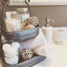 a metal basket filled with lots of items on top of a bathroom counter