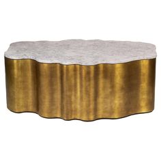 a gold and white marble coffee table with an oval shaped design on the top, in front of a white background