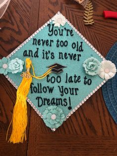 a blue graduation cap that says, you're never too old and it's never too late to follow your dreams