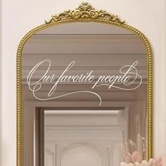 an ornate gold framed mirror with the words our favorite french written in cursive writing