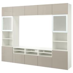 a white and beige entertainment center with shelves on each side that has a large mirror above it