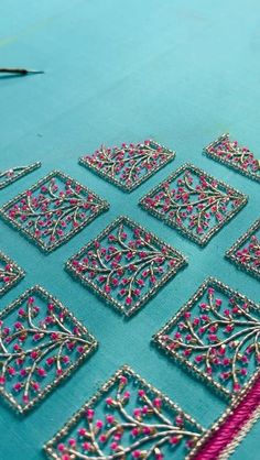 a table topped with lots of different types of beading on top of blue cloth