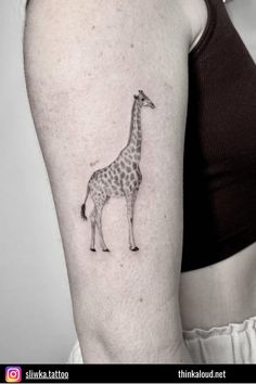 a small giraffe tattoo on the right upper half of the arm and shoulder