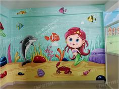 a child's room painted with an underwater scene and sea animals on the wall