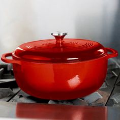 a red pot sitting on top of a stove