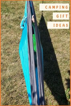 a boy is climbing up the side of a tent with text overlay reading camping gift ideas