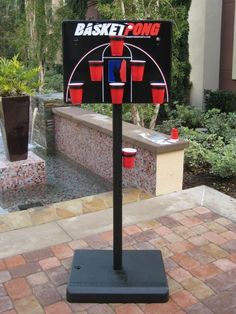 a basketball game set up in front of a fountain with buckets on the side