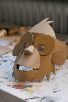 an animal made out of cardboard sitting on top of a table