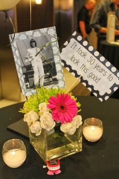 flowers and candles sit on a table with a sign that says, it's my year to be this lady