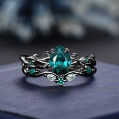 a ring with an oval cut blue topazte surrounded by vines