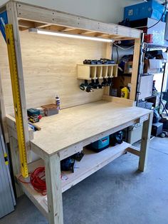 a workbench is being built in a garage with tools on the table and shelves