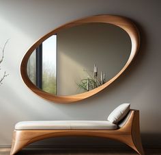 a wooden bench sitting in front of a round mirror on the side of a wall