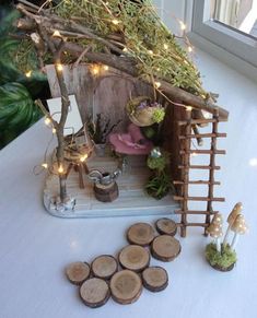 a miniature house made out of wood with fairy lights