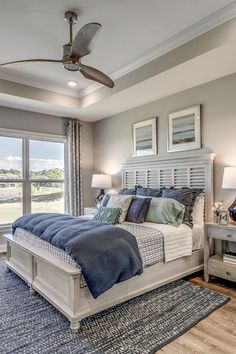 a bedroom with a large bed and ceiling fan