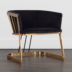 a black and gold chair sitting on top of a hard wood floor