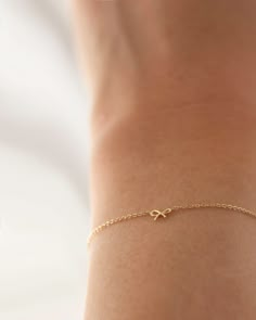 This 14k gold bracelet features a delicate bow, making it ideal for everyday wear. Its petite design is perfect for making a subtle statement. * 14k Yellow Gold * Bow measures approx. 6mm * Same Style Necklace: https://www.etsy.com/listing/1611306083/14k-gold-dainty-bow-necklace-tiny-bow?click_key=9dd688161579bb004abb4ef357dff8734744d24e%3A1611306083&click_sum=7aed8dbc&ref=shop_home_active_3&frs=1&sts=1 ■ SHIPPING UPGRADES You can find shipping upgrades options in the drop bar menu when you check out. * Within the U.S Regular First-class : 2-6 business days Priority : 2-3days Express : 1-2 days * International International Priority : 6-10 Business days Rush International Express : 3-6 business days * Our current processing time is 2-7 business days. Please note that shipping times do NOT Bracelets Minimalist, خواتم خطوبة, Cute Jewellery, Cute Bracelet, Bracelets Ideas, Tiny Bow, Mini Bow