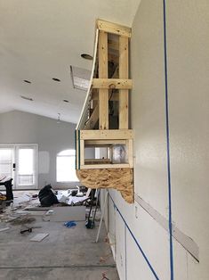 a room that is being remodeled with unfinished walls and wood trimmings on the wall