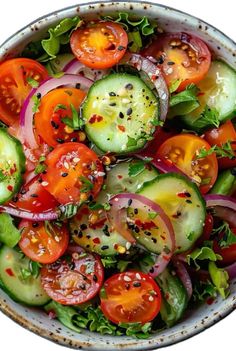 a salad with cucumbers, tomatoes, onions and sesame seeds in a bowl